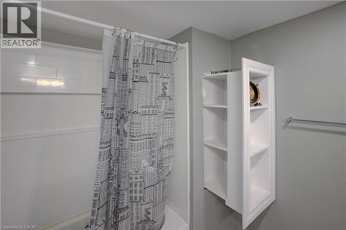White subway tile shower surround with a built-in recessed shelving unit - 53 Prosperity Drive, Kitchener, ON - Indoor Photo Showing Bathroom