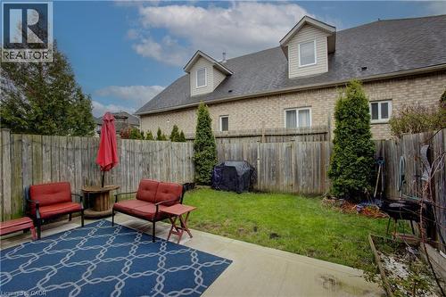 Private backyard featuring a concrete patio, fenced perimeter, and a manicured lawn - 53 Prosperity Drive, Kitchener, ON - Outdoor