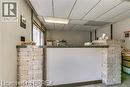 Reception counter featuring stone block accents and a dark-toned countertop - 9 Meadow Lane S, Hamilton, ON 
