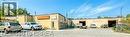 Multi-building commercial property featuring a large asphalt parking area - 9 Meadow Lane S, Hamilton, ON 
