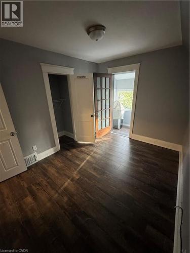 Room featuring dark wood-finish flooring, light gray walls, and white trim - 61 Waterloo Drive, Kitchener, ON - Indoor Photo Showing Other Room