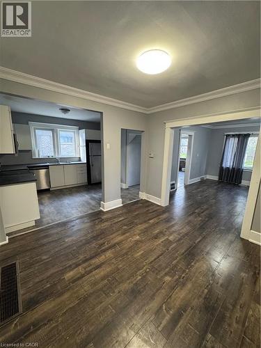 Open-concept living area featuring wood-finish flooring, crown molding, and recessed lighting - 61 Waterloo Drive, Kitchener, ON - Indoor
