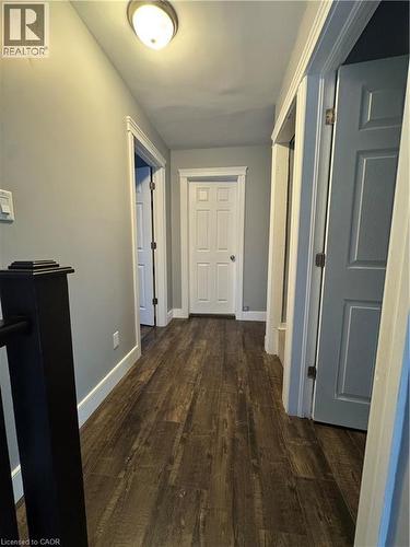 Hallway featuring durable wood-finish flooring, light gray wall paint, and white trim - 61 Waterloo Drive, Kitchener, ON - Indoor Photo Showing Other Room