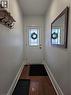 Entryway featuring a white door with decorative glass inserts, wood-finish flooring, and white baseboards - 125 Cavell Avenue, Hamilton, ON  - Indoor Photo Showing Other Room 