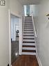 Staircase with dark wood-finish treads and white risers, complemented by a white handrail - 125 Cavell Avenue, Hamilton, ON  - Indoor Photo Showing Other Room 