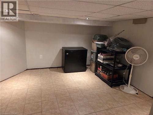 Tiled flooring throughout a neutral-toned room featuring a drop ceiling with recessed lighting - 125 Cavell Avenue, Hamilton, ON - Indoor Photo Showing Other Room