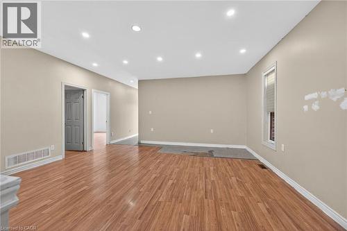 Spacious interior featuring wood-finish flooring, recessed lighting, and neutral wall tones - 704 Stone Church Road E, Hamilton, ON - Indoor Photo Showing Other Room