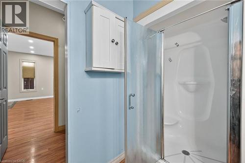 Walk-in shower with a glass enclosure, integrated seating, and a chrome showerhead - 704 Stone Church Road E, Hamilton, ON - Indoor Photo Showing Bathroom