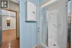 Walk-in shower with a glass enclosure, integrated seating, and a chrome showerhead - 