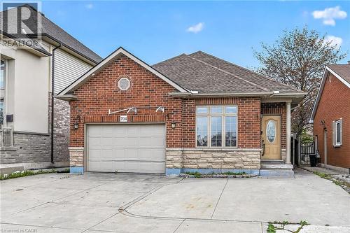 Brick exterior with stone accents and a gabled roofline - 704 Stone Church Road E, Hamilton, ON - Outdoor