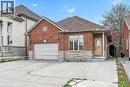 Brick and stone facade residence featuring a single-car garage with an overhead door, a concrete driveway, and a covered front entry with a decorative glass door - 704 Stone Church Road E, Hamilton, ON  - Outdoor With Facade 