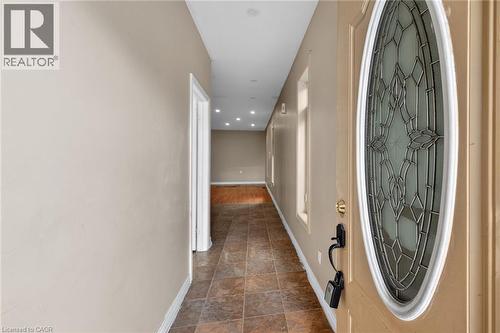Entryway featuring a decorative oval glass door with brass hardware - 704 Stone Church Road E, Hamilton, ON - Indoor Photo Showing Other Room