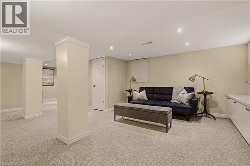Carpeted room featuring recessed lighting, painted walls, white trim, and built-in cabinetry with a countertop - 104 Barnesdale Avenue N, Hamilton, ON - Indoor