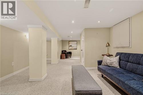 Finished lower level featuring recessed lighting, light-toned carpeting, painted support columns, and neutral wall tones - 104 Barnesdale Avenue N, Hamilton, ON - Indoor