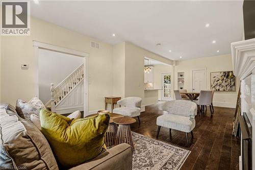 Spacious living area featuring dark wood-finish flooring, recessed lighting, and a prominent white mantelpiece - 104 Barnesdale Avenue N, Hamilton, ON - Indoor Photo Showing Living Room