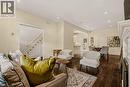 Spacious living area featuring dark wood-finish flooring, recessed lighting, and a prominent white mantelpiece - 104 Barnesdale Avenue N, Hamilton, ON  - Indoor Photo Showing Living Room 