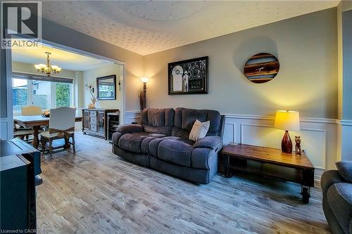 Wood-finish flooring extending into an open dining area - 146 Locheed Drive, Hamilton, ON - Indoor Photo Showing Living Room
