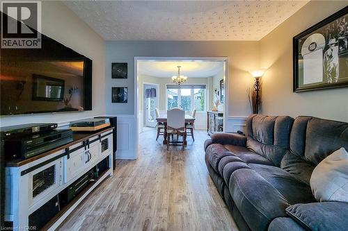 Inviting living space featuring wood-finish flooring, a neutral wall palette, and panel wainscoting - 146 Locheed Drive, Hamilton, ON - Indoor Photo Showing Living Room