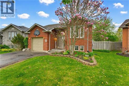 Brick exterior with a single-car garage and a paved driveway - 29 Strong Court, Brantford, ON - Outdoor