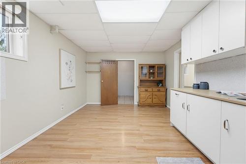 Room featuring wood-finish flooring, white baseboards, and neutral wall paint - 29 Strong Court, Brantford, ON - Indoor
