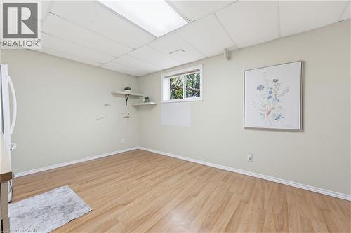 Spacious room featuring wood-finish flooring and a drop ceiling - 29 Strong Court, Brantford, ON - Indoor Photo Showing Other Room