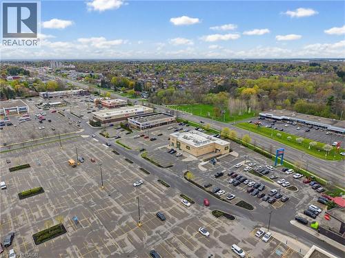 Retail plaza with multiple commercial buildings and extensive asphalt parking - 29 Strong Court, Brantford, ON - Outdoor With View