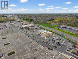Retail plaza with multiple commercial buildings and extensive asphalt parking - 