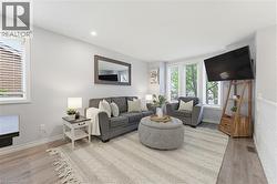 Living area featuring light wood-finish flooring and neutral wall tones - 