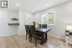 Dining area featuring light wood-finish flooring and recessed ceiling lighting - 