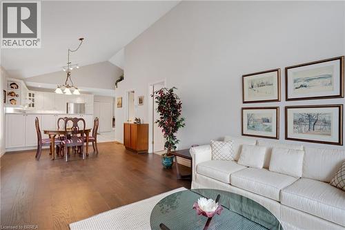 Open-concept living space featuring wood-finish flooring, vaulted ceilings, and recessed lighting - 422 Powerline Road Unit# 10, Brantford, ON - Indoor Photo Showing Living Room