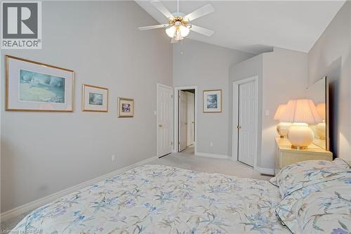 Vaulted ceiling with a ceiling fan, light gray wall paint, light-colored carpeting, two white interior doors, and white baseboards - 422 Powerline Road Unit# 10, Brantford, ON - Indoor Photo Showing Bedroom