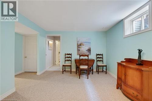 Carpeted room featuring light blue walls, white trim, and a high-set window - 422 Powerline Road Unit# 10, Brantford, ON - Indoor