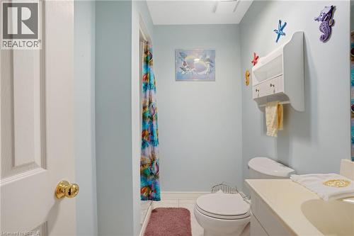 Bathroom featuring light blue walls, white trim, and a built-in vanity with integrated sink - 422 Powerline Road Unit# 10, Brantford, ON - Indoor Photo Showing Bathroom