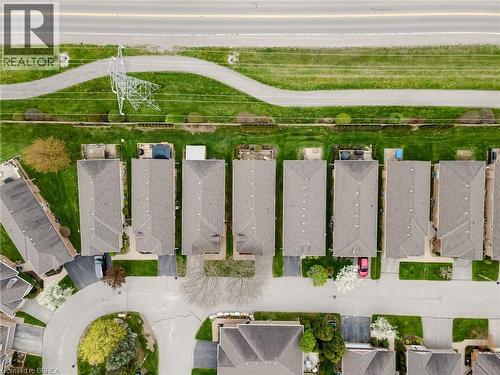 Aerial view of a residential community featuring multiple homes with gray shingle roofs - 422 Powerline Road Unit# 10, Brantford, ON - Outdoor With View