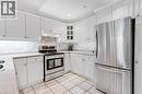 Modern kitchen featuring white cabinetry, light-toned countertops, stainless steel appliances, and a subway tile backsplash - 422 Powerline Road Unit# 10, Brantford, ON  - Indoor Photo Showing Kitchen With Stainless Steel Kitchen 
