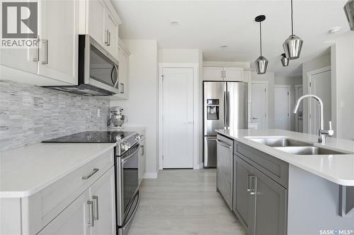 3181 Mazurak Crescent, Regina, SK - Indoor Photo Showing Kitchen With Stainless Steel Kitchen With Double Sink With Upgraded Kitchen