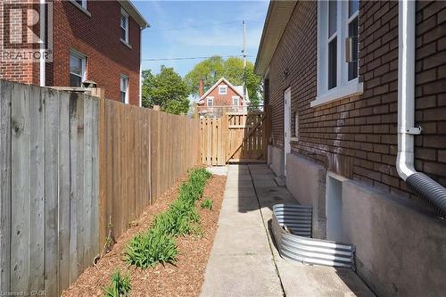 Landscaped side yard with side entrance to home. - 123 Samuel Street, Kitchener, ON - Outdoor With Exterior