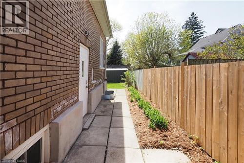 Landscaped side yard with side entrance to home. - 123 Samuel Street, Kitchener, ON - Outdoor With Exterior