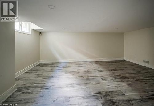 Spacious room featuring wood-finish flooring, light-toned walls, and recessed ceiling lighting - 33 Sixth Avenue, Kitchener, ON - Indoor Photo Showing Other Room
