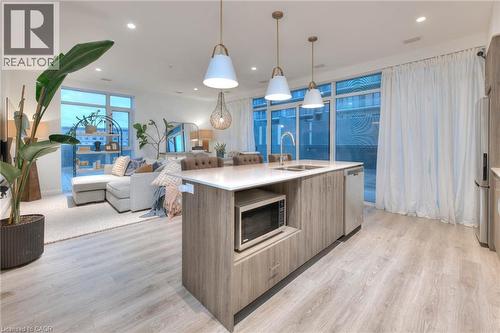 Kitchen featuring modern cabinets, an island with sink, stainless steel appliances, and light wood-type flooring - 50 Grand Avenue S Unit# 602, Cambridge, ON - Indoor