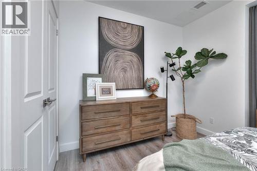 Bedroom with light wood-style flooring and baseboards - 50 Grand Avenue S Unit# 602, Cambridge, ON - Indoor Photo Showing Bedroom