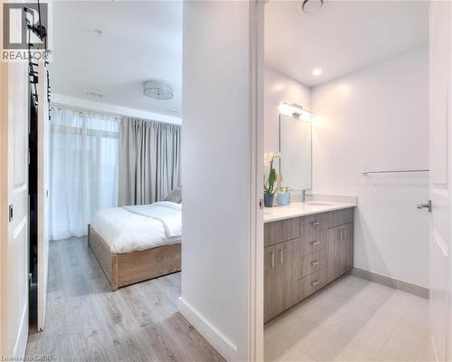 Ensuite bathroom featuring double vanity, light wood finished floors, and recessed lighting - 50 Grand Avenue S Unit# 602, Cambridge, ON - Indoor Photo Showing Bathroom