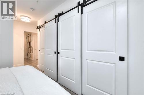 Bedroom featuring a barn door - 50 Grand Avenue S Unit# 602, Cambridge, ON - Indoor Photo Showing Bedroom