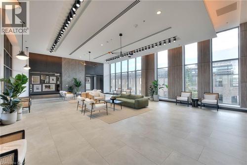 Building lobby featuring expansive windows, a high ceiling, and rail lighting - 50 Grand Avenue S Unit# 602, Cambridge, ON - Indoor