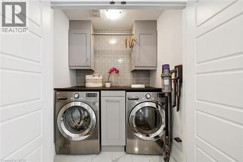 Dedicated laundry area featuring front-loading washer and dryer units - 72 Elmbank Trail, Kitchener, ON - Indoor Photo Showing Laundry Room