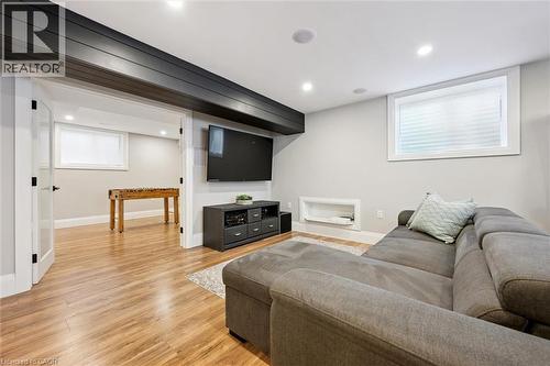 Recreation room featuring wood-finish flooring, recessed lighting, and a built-in media niche - 72 Elmbank Trail, Kitchener, ON - Indoor