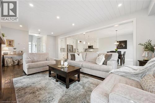Expansive living area featuring rich wood-finish flooring and a distinctive shiplap ceiling with recessed lighting - 72 Elmbank Trail, Kitchener, ON - Indoor Photo Showing Living Room