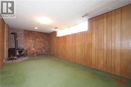 Basement recreation room featuring airtight wood stove - 76 Cloverdale Crescent, Kitchener, ON - Indoor