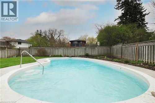 Luxurious gunite pool framed by stamped concrete patio - 76 Cloverdale Crescent, Kitchener, ON - Outdoor With In Ground Pool With Backyard