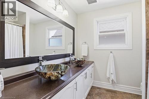 Contemporary bathroom featuring a double vanity with vessel sinks, a large framed mirror, and a window with white trim - 19 Forestview Drive, Cambridge, ON - Indoor Photo Showing Bathroom